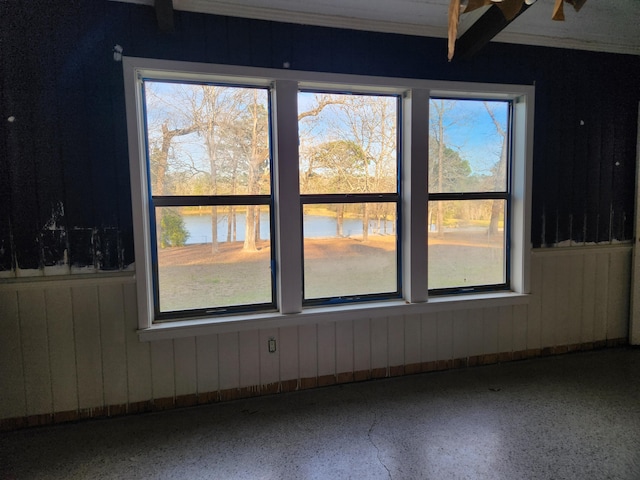 5131 Wiggins Lake Rd, Walnut Hill, FL 32568 - empty room featuring speckled floor, a water view, and wooden walls