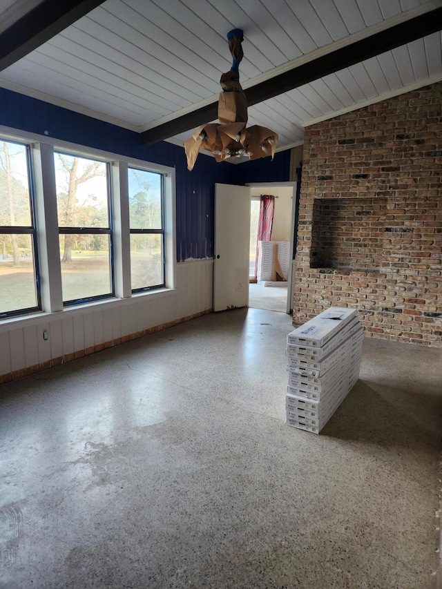 5131 Wiggins Lake Rd, Walnut Hill, FL 32568 - unfurnished living room featuring brick wall and beam ceiling