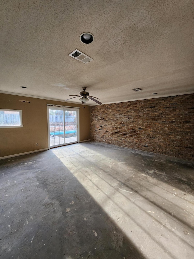 5131 Wiggins Lake Rd, Walnut Hill, FL 32568 - spare room with brick wall, a textured ceiling, ceiling fan, and unfinished concrete floors