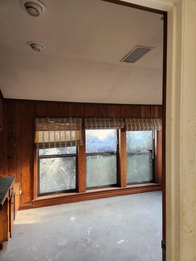 5131 Wiggins Lake Rd, Walnut Hill, FL 32568 - spare room featuring concrete floors, healthy amount of natural light, and wooden walls