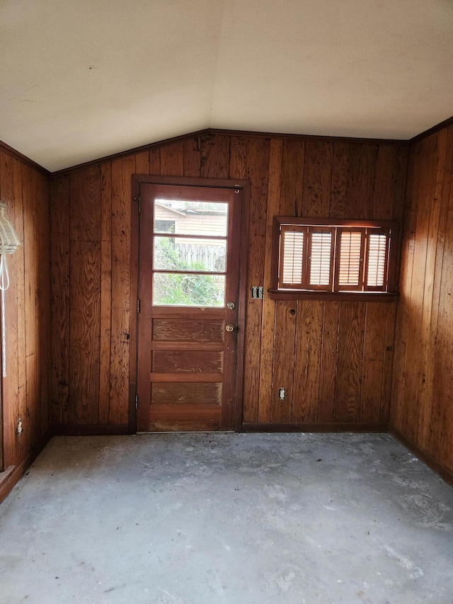 5131 Wiggins Lake Rd, Walnut Hill, FL 32568 - spare room featuring unfinished concrete flooring, wooden walls, and vaulted ceiling