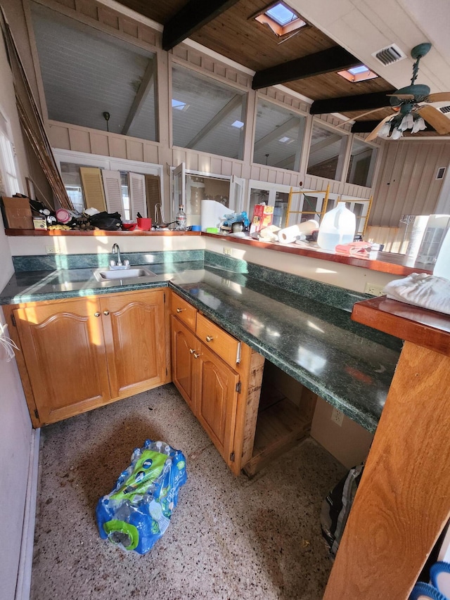 5131 Wiggins Lake Rd, Walnut Hill, FL 32568 - kitchen featuring dark speckled floor, a ceiling fan, and dark countertops