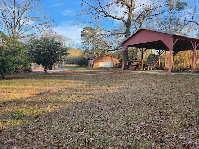 5131 Wiggins Lake Rd, Walnut Hill, FL 32568 - view of green lawn featuring a detached garage and an outbuilding