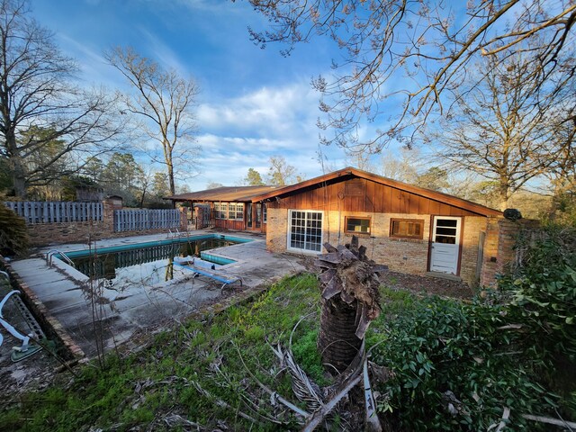 5131 Wiggins Lake Rd, Walnut Hill, FL 32568 - rear view of house with brick siding and a patio area
