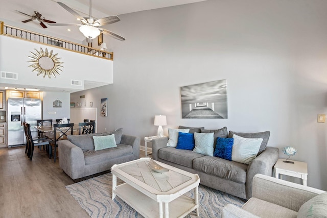 3290 Scenic Highway 98 Unit 305B, Destin, FL 32541 - living area with light wood finished floors, ceiling fan, and a towering ceiling