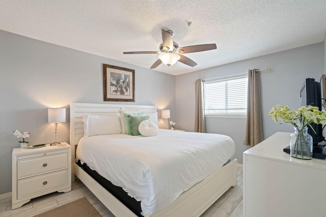 3290 Scenic Highway 98 Unit 305B, Destin, FL 32541 - bedroom with a textured ceiling, wood finish floors, and ceiling fan