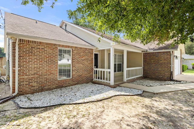 4601 Top Flight Dr, Crestview, FL 32539 - rear view of house featuring brick siding, roof with shingles, and a porch
