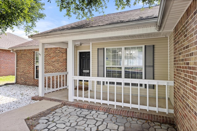 4601 Top Flight Dr, Crestview, FL 32539 - doorway to property featuring brick siding, covered porch, and a shingled roof