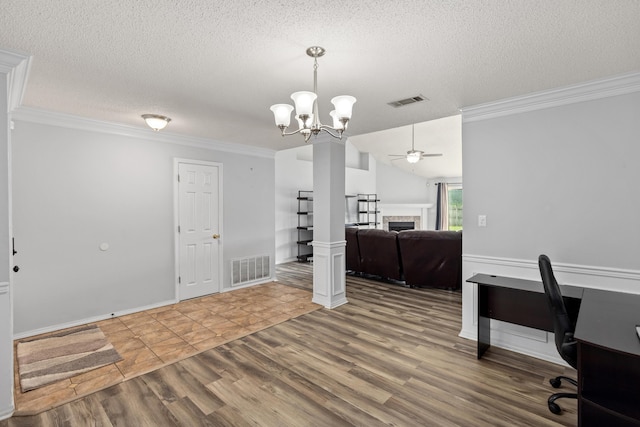 4601 Top Flight Dr, Crestview, FL 32539 - office space featuring crown molding, a fireplace, ceiling fan, wood finished floors, and a textured ceiling