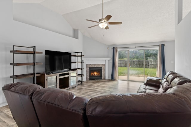 4601 Top Flight Dr, Crestview, FL 32539 - living room with wood finished floors, lofted ceiling, a tile fireplace, and ceiling fan