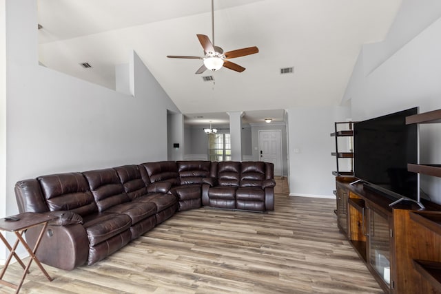 4601 Top Flight Dr, Crestview, FL 32539 - living area featuring high vaulted ceiling, a ceiling fan, wood finished floors, and decorative columns