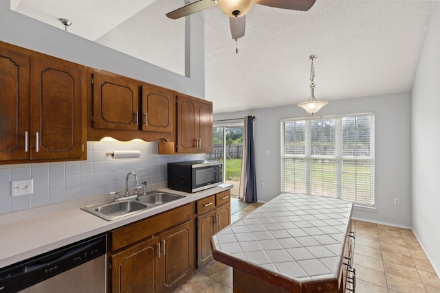 4601 Top Flight Dr, Crestview, FL 32539 - kitchen featuring stainless steel appliances, backsplash, a ceiling fan, light tile patterned flooring, and vaulted ceiling