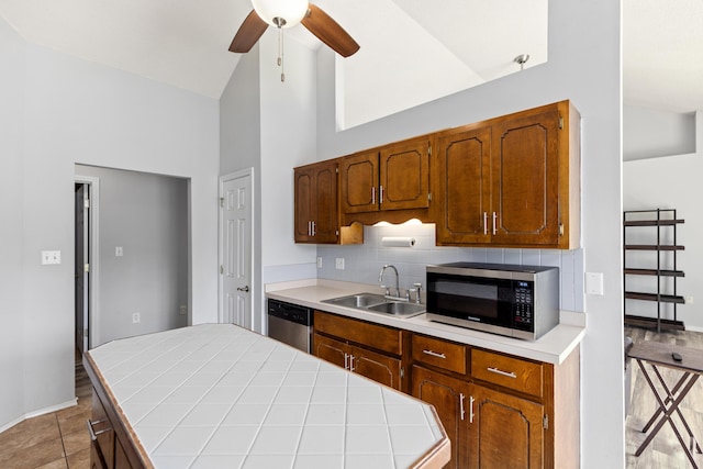 4601 Top Flight Dr, Crestview, FL 32539 - kitchen featuring appliances with stainless steel finishes, backsplash, a center island, a ceiling fan, and high vaulted ceiling
