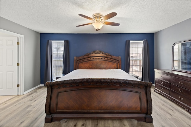 4601 Top Flight Dr, Crestview, FL 32539 - bedroom featuring light wood-style floors, a ceiling fan, and a textured ceiling
