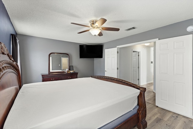 4601 Top Flight Dr, Crestview, FL 32539 - bedroom with light wood-style flooring, a ceiling fan, and a textured ceiling