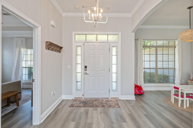 138 Crab Apple Ave, Crestview, FL 32536 - entrance foyer featuring wood finished floors, healthy amount of natural light, crown molding, and a chandelier