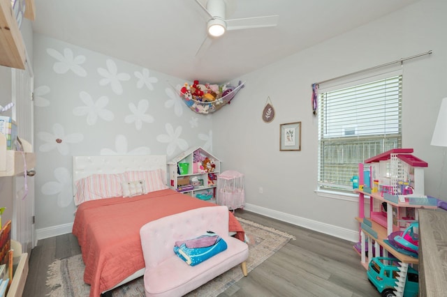 138 Crab Apple Ave, Crestview, FL 32536 - bedroom featuring wood finished floors, wallpapered walls, ceiling fan, and an accent wall