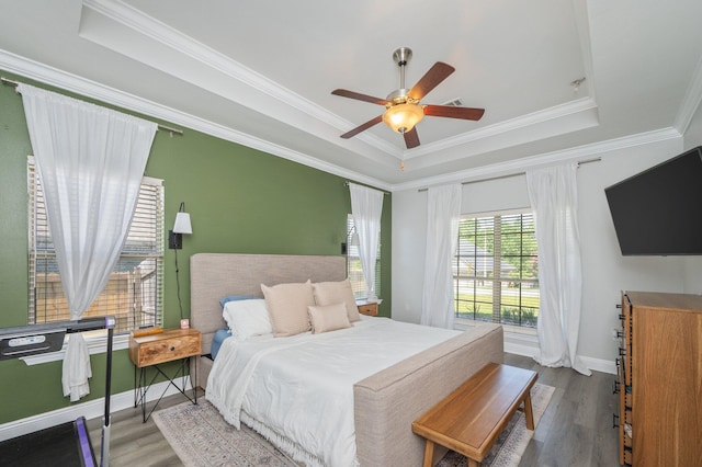138 Crab Apple Ave, Crestview, FL 32536 - bedroom featuring a tray ceiling, wood finished floors, crown molding, and a ceiling fan