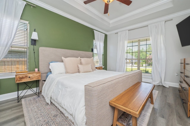 138 Crab Apple Ave, Crestview, FL 32536 - bedroom featuring wood finished floors, crown molding, a raised ceiling, and ceiling fan
