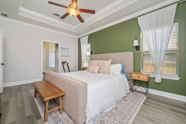 138 Crab Apple Ave, Crestview, FL 32536 - bedroom with wood finished floors, a tray ceiling, crown molding, and ceiling fan