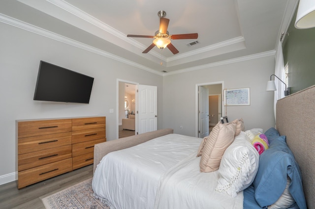 138 Crab Apple Ave, Crestview, FL 32536 - bedroom featuring light wood-style floors, a raised ceiling, ornamental molding, and a ceiling fan