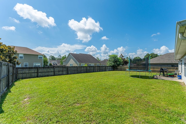 138 Crab Apple Ave, Crestview, FL 32536 - fenced backyard featuring a trampoline, a patio, and a residential view