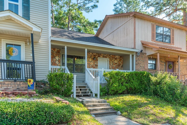 1207 Walter Ave, Crestview, FL 32536 - view of front of house with a porch, roof with shingles, and brick siding