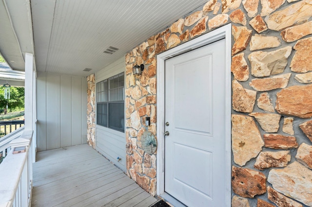 1207 Walter Ave, Crestview, FL 32536 - doorway to property with stone siding and covered porch