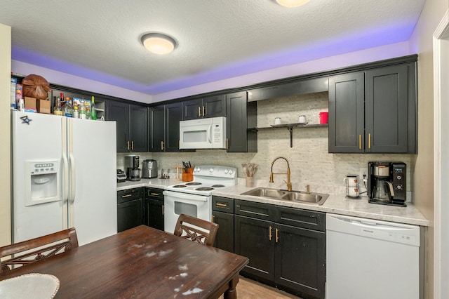 1207 Walter Ave, Crestview, FL 32536 - kitchen featuring white appliances, open shelves, light countertops, tasteful backsplash, and dark cabinetry
