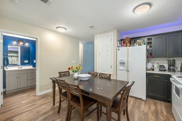1207 Walter Ave, Crestview, FL 32536 - dining space with light wood-type flooring and a textured ceiling