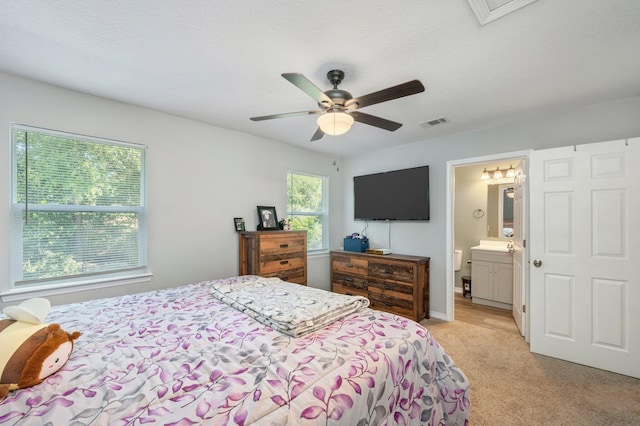 1207 Walter Ave, Crestview, FL 32536 - bedroom featuring light colored carpet, ceiling fan, and connected bathroom