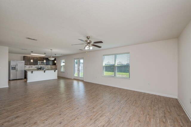 728 Widgeon Way, Crestview, FL 32539 - unfurnished living room with wood finished floors and ceiling fan