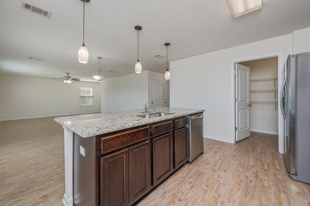 728 Widgeon Way, Crestview, FL 32539 - kitchen featuring stainless steel appliances, light wood-style floors, ceiling fan, and dark brown cabinetry