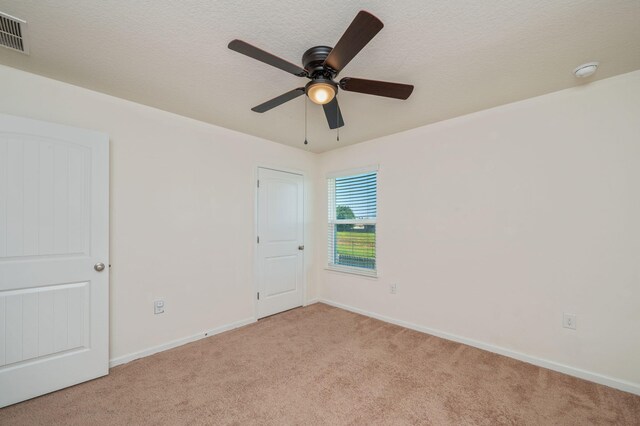 728 Widgeon Way, Crestview, FL 32539 - spare room with light colored carpet, a smoke detector, and a ceiling fan