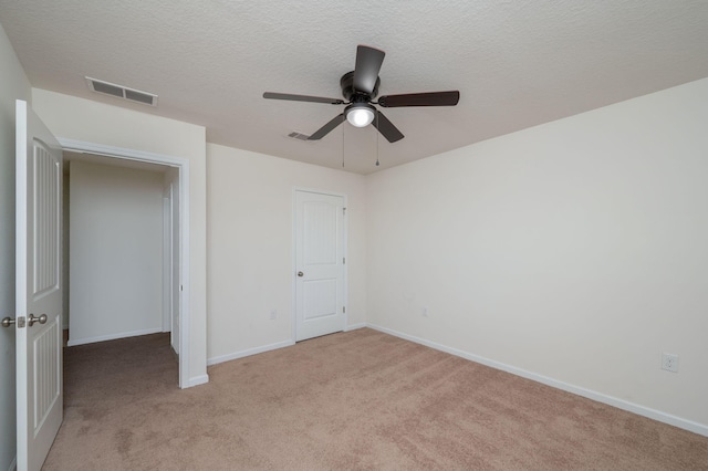 728 Widgeon Way, Crestview, FL 32539 - unfurnished bedroom featuring light colored carpet, a ceiling fan, and a textured ceiling