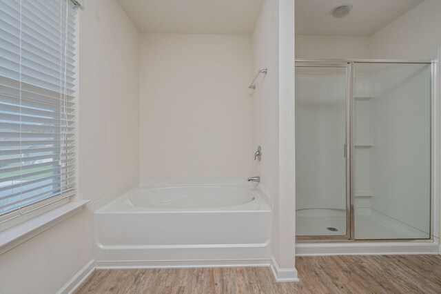 728 Widgeon Way, Crestview, FL 32539 - full bathroom with wood finished floors, a stall shower, and a bath