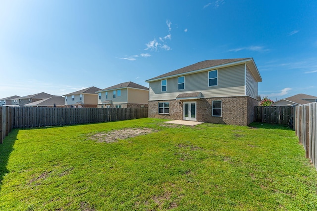728 Widgeon Way, Crestview, FL 32539 - rear view of house with brick siding, french doors, a patio area, and a fenced backyard