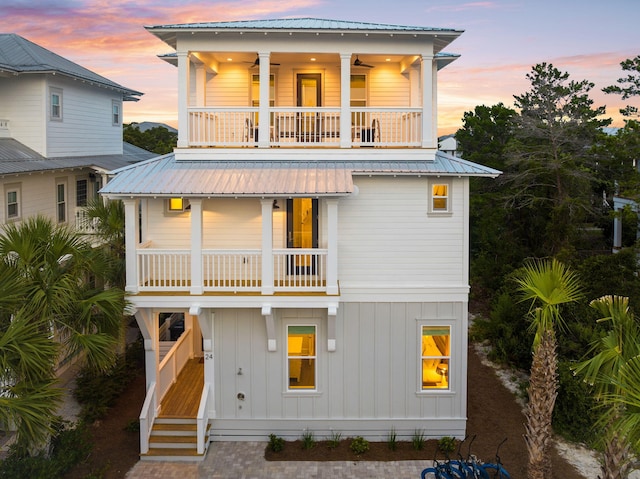 24 Barefoot Ln, Inlet Beach, FL 32461 - view of front facade with a balcony, board and batten siding, ceiling fan, stairs, and a metal roof