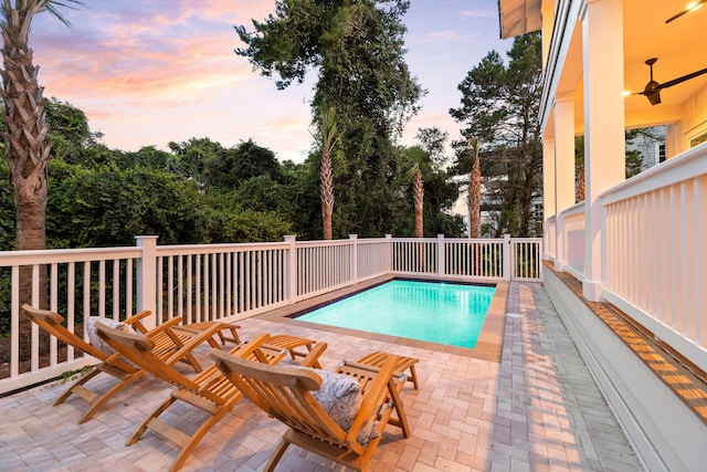 24 Barefoot Ln, Inlet Beach, FL 32461 - pool at dusk featuring a ceiling fan and a patio