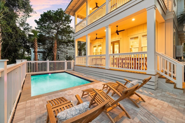 24 Barefoot Ln, Inlet Beach, FL 32461 - pool at dusk featuring ceiling fan, a patio area, and an outdoor pool