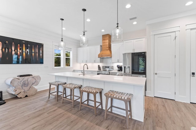 24 Barefoot Ln, Inlet Beach, FL 32461 - kitchen with stainless steel appliances, premium range hood, light wood-style flooring, a kitchen bar, and recessed lighting