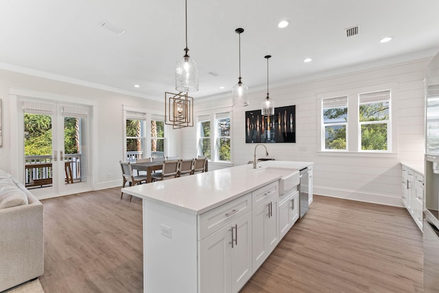 24 Barefoot Ln, Inlet Beach, FL 32461 - kitchen featuring light countertops, recessed lighting, light wood-type flooring, ornamental molding, and white cabinets
