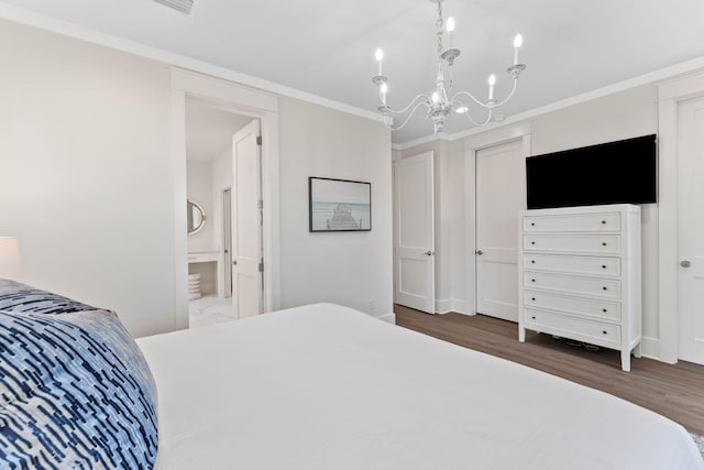 24 Barefoot Ln, Inlet Beach, FL 32461 - bedroom with wood finished floors, a chandelier, crown molding, and ensuite bathroom