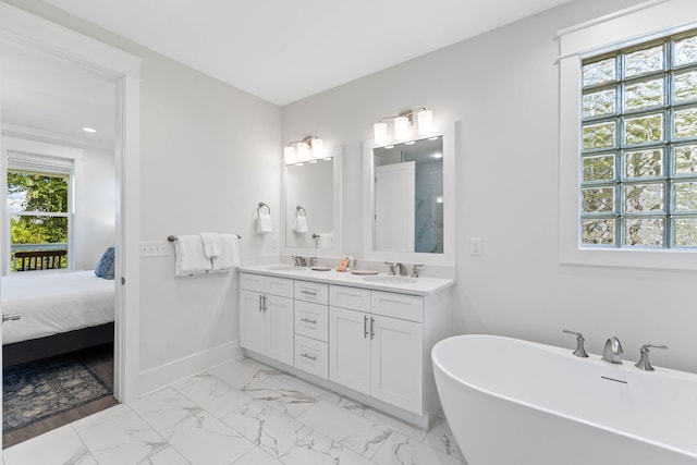 24 Barefoot Ln, Inlet Beach, FL 32461 - ensuite bathroom featuring double vanity, a freestanding tub, marble look tiles, and recessed lighting