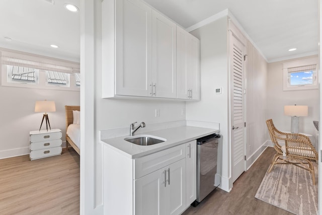 24 Barefoot Ln, Inlet Beach, FL 32461 - kitchen featuring light wood-type flooring, dishwasher, white cabinetry, light countertops, and ornamental molding