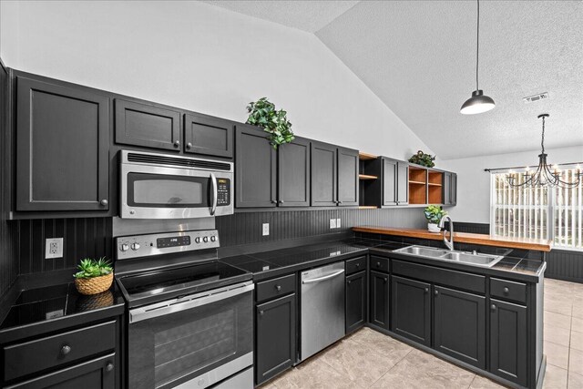 5408 Josh Dr, Crestview, FL 32536 - kitchen featuring stainless steel appliances, vaulted ceiling, a peninsula, open shelves, and a chandelier