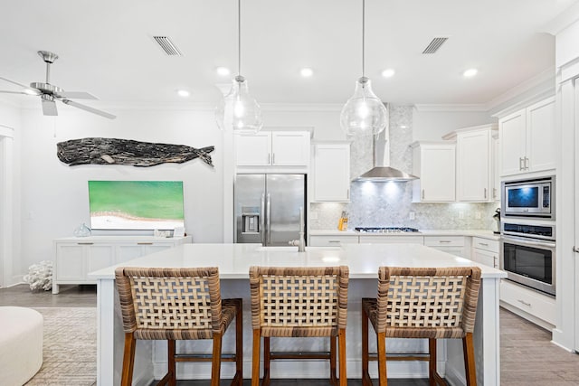 209 Milestone Dr Unit A, Inlet Beach, FL 32461 - kitchen with stainless steel appliances, a kitchen island with sink, light countertops, backsplash, and white cabinetry