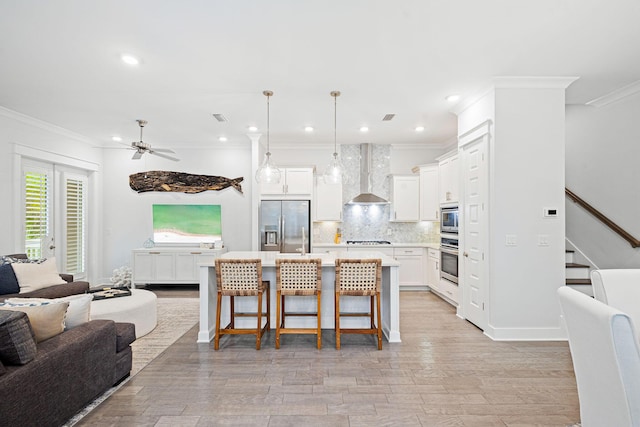 209 Milestone Dr Unit A, Inlet Beach, FL 32461 - kitchen with appliances with stainless steel finishes, open floor plan, wall chimney range hood, a ceiling fan, and backsplash
