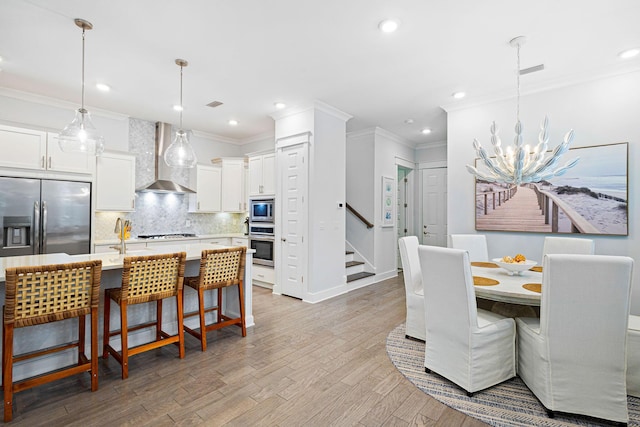 209 Milestone Dr Unit A, Inlet Beach, FL 32461 - dining area featuring a chandelier, recessed lighting, stairs, light wood-style floors, and ornamental molding