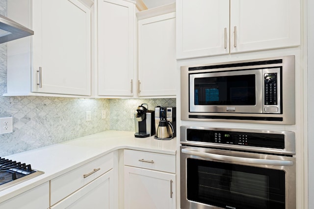 209 Milestone Dr Unit A, Inlet Beach, FL 32461 - kitchen with stainless steel appliances, decorative backsplash, and white cabinetry